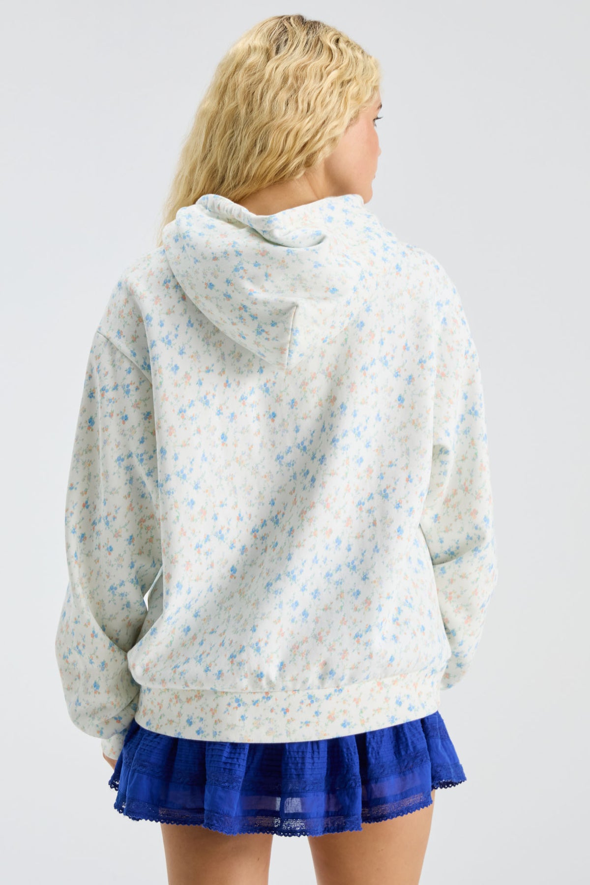 Light blue speckle hoodie with hood and drawstring, back view with layered blue hem