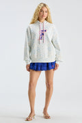 Graphic pullover hoodie with hood and pink drawstring, light blue speckle pattern