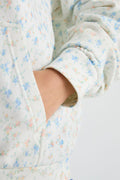 Light blue speckled hoodie sleeve with ribbed cuff and front pocket seam detail