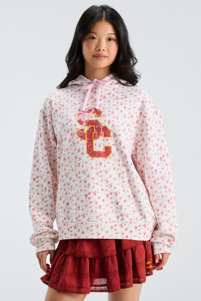 Pink floral pullover hoodie with hood and pink drawstring, gold-and-navy front graphic