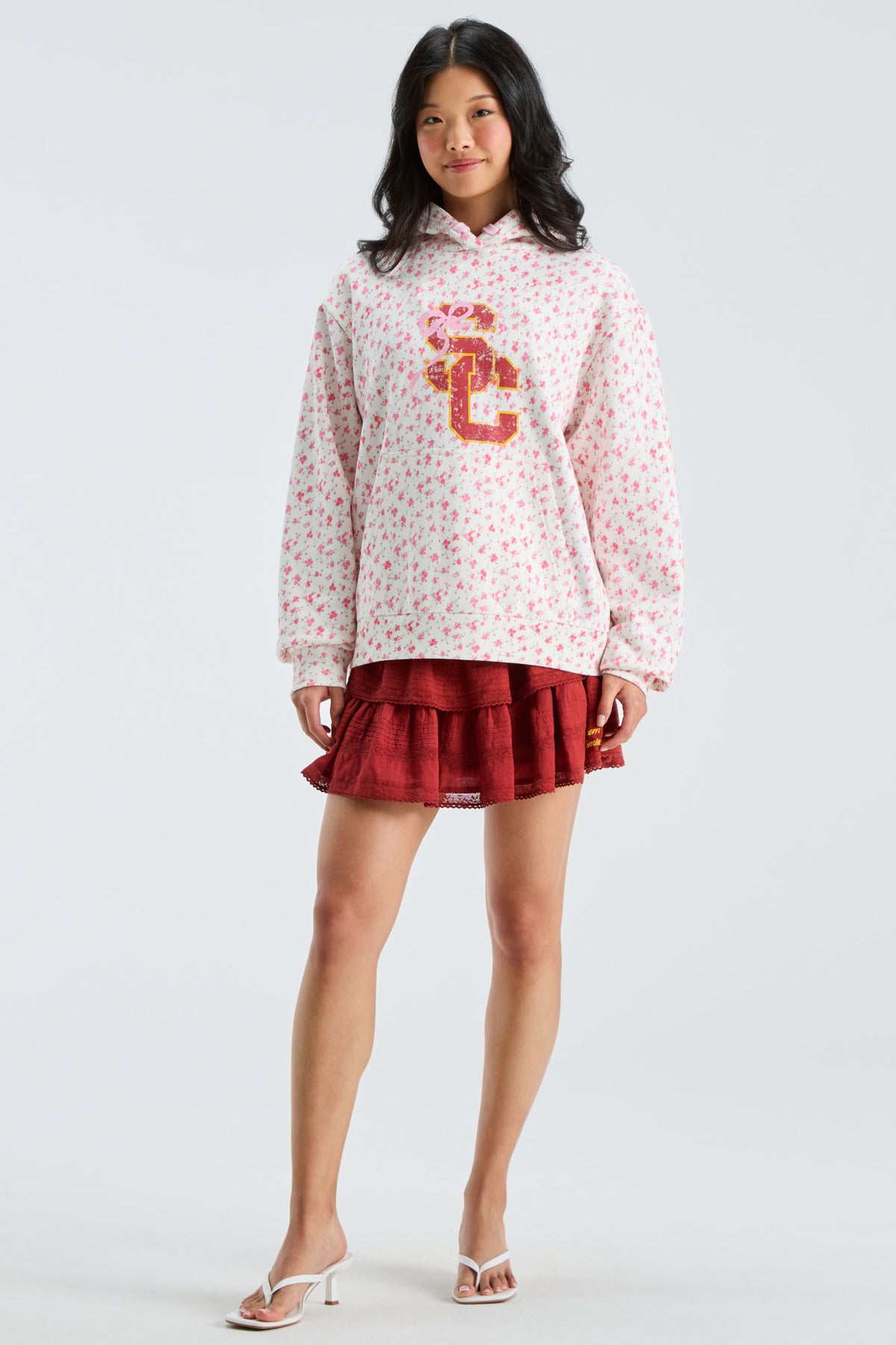 Pink floral pullover hoodie with hood drawstring and large front graphic, red skirt overlay