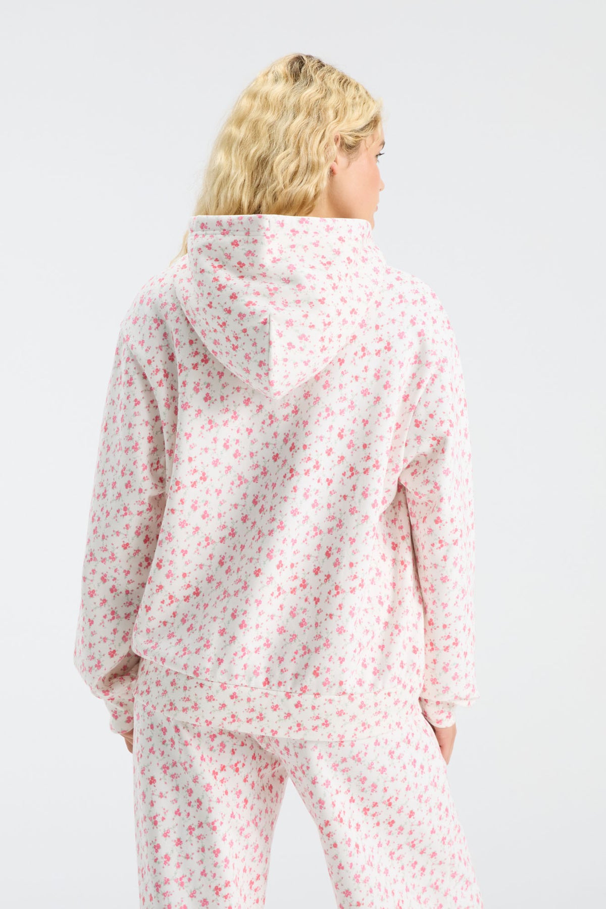 Pink floral pullover hoodie from back with hood and full-length sleeves