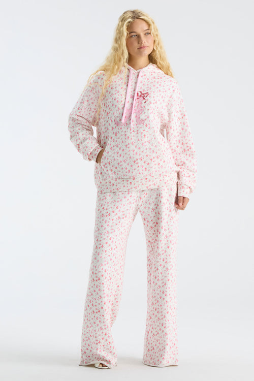 Pink floral pajama-style sweatpants with drawstring waist and wide legs