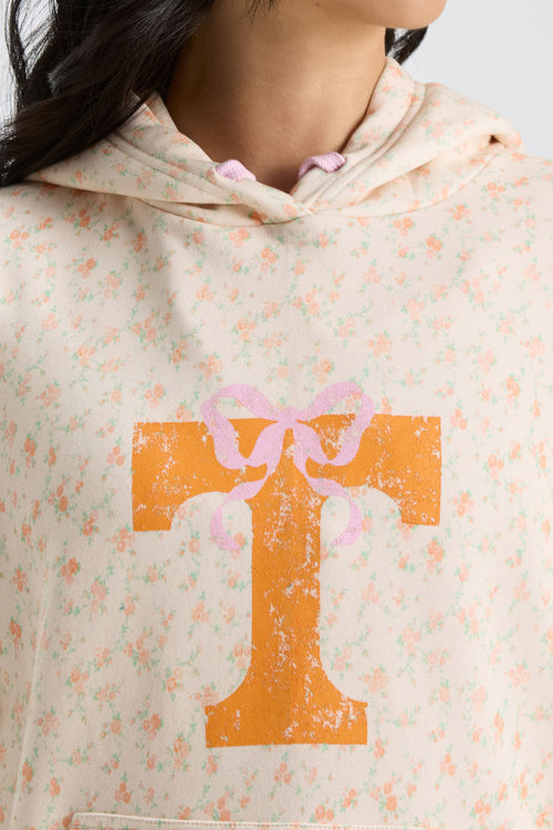 Cream floral hoodie close-up of hood and drawstring with orange graphic cross