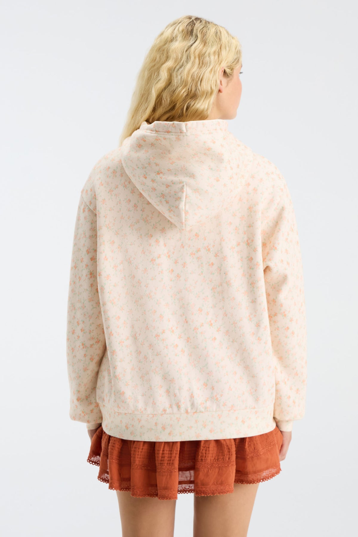 Cream patterned Nacova hoodie with hood and kangaroo pocket, back view.