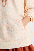 Cream patterned Nacova hoodie sleeve detail with drawstring hood and kangaroo pocket.