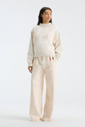 Cream mockneck crew sweatshirt with “FANATICS” floral lettering across the chest