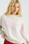 Cream mockneck crew sweatshirt with large pastel “LOVE” applique on chest