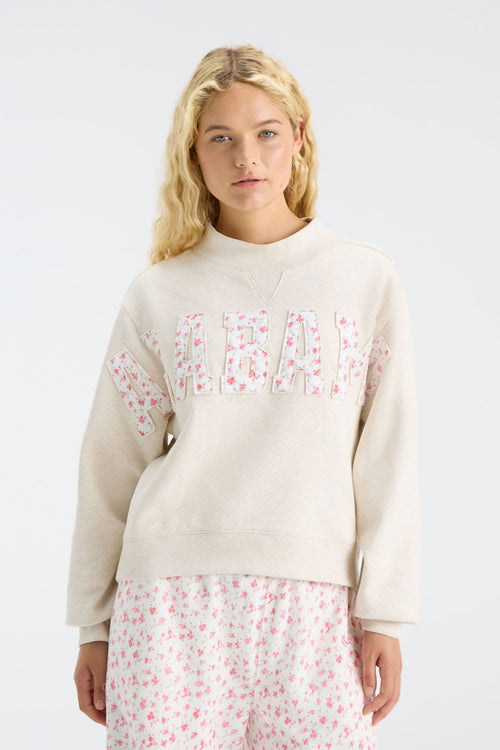 Cream mockneck crew sweatshirt with pink floral “U S C” letter graphic and long sleeves