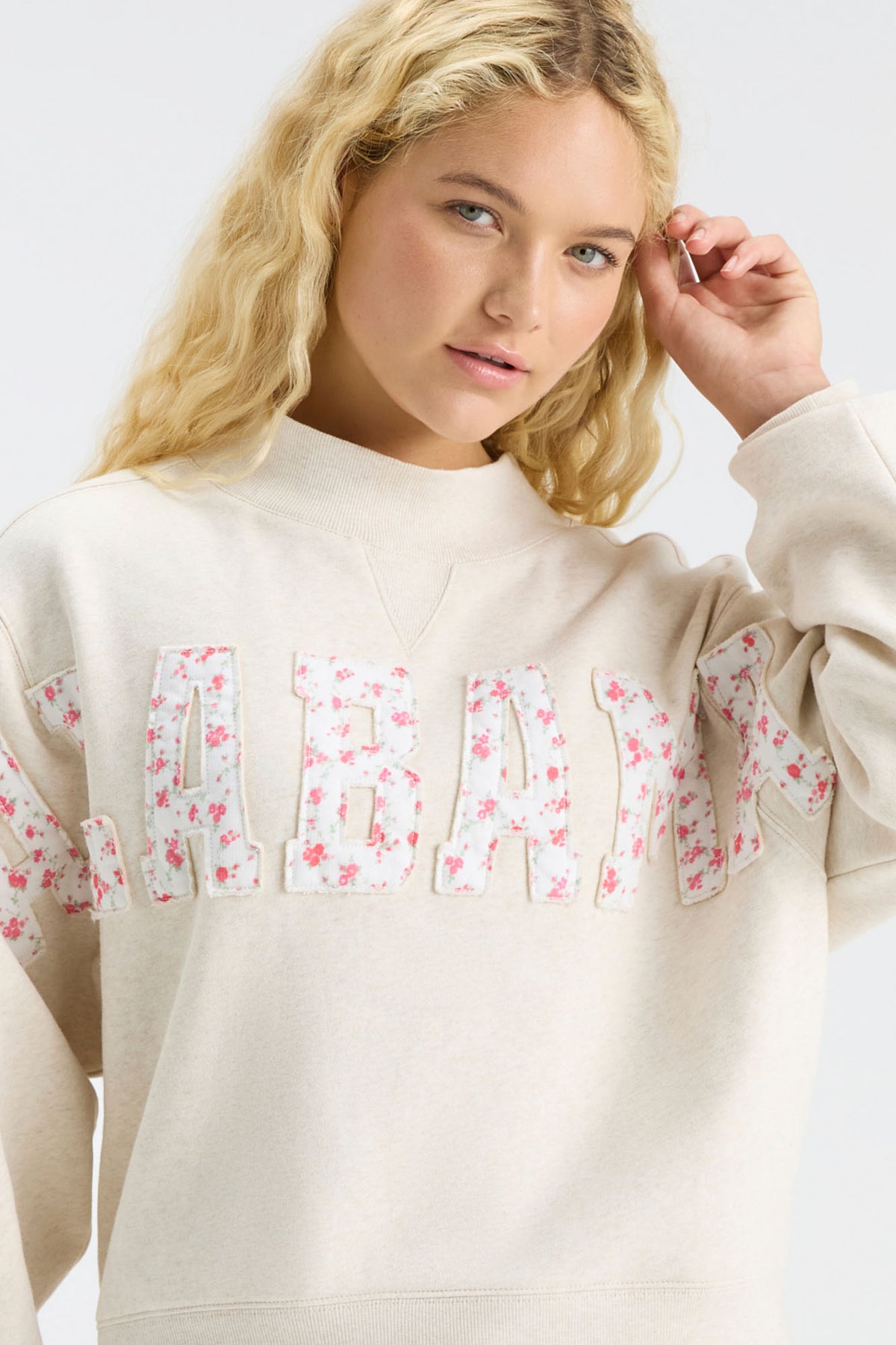 Cream mockneck crew sweatshirt detail of pink floral “U S C” letter print