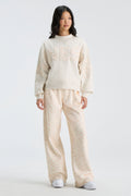 Cream mockneck sweatshirt with "LOVE" graphic and matching long-sleeve fit