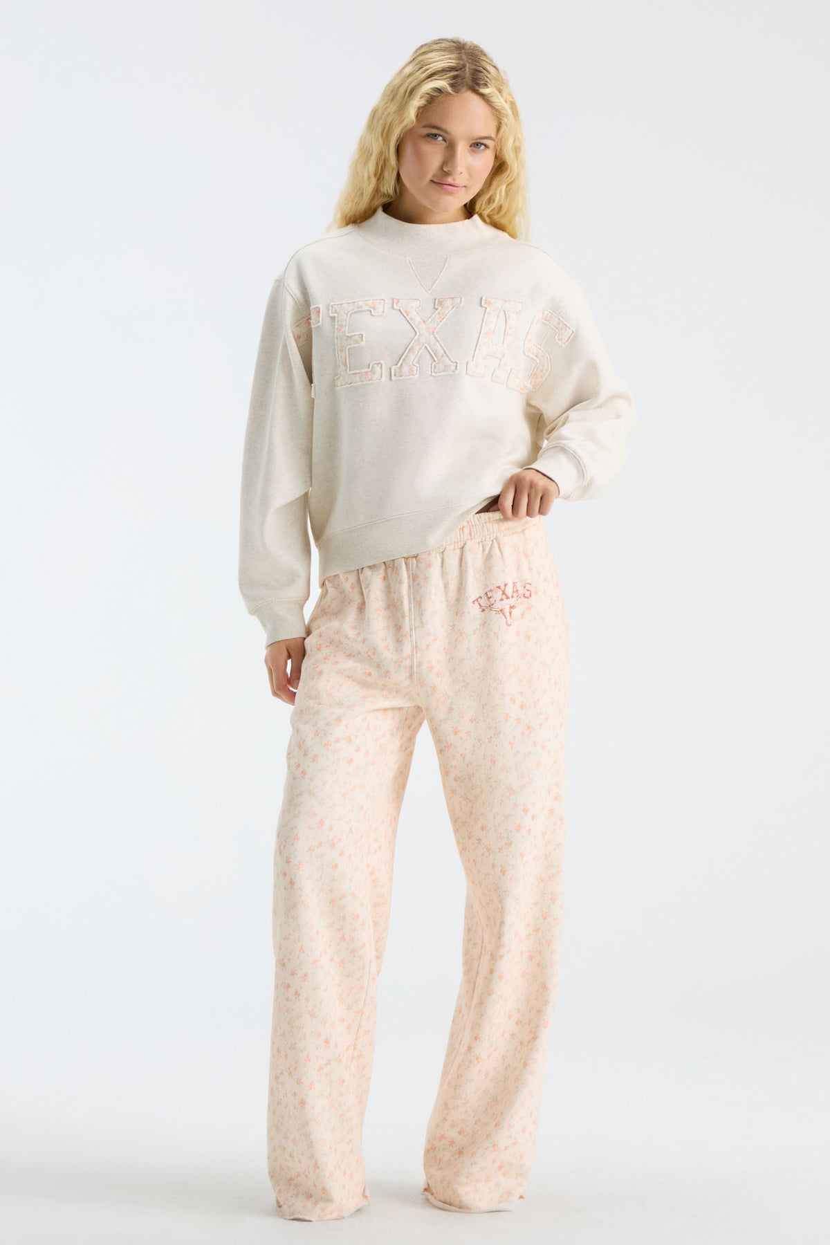 Cream mockneck sweatshirt with "LOVE" graphic and loose sleeves