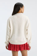 Back view of cream mockneck crew sweatshirt with small logo at upper back