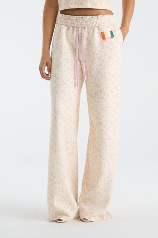 Cream floral-print wide-leg sweatpants with elastic waist and drawstring