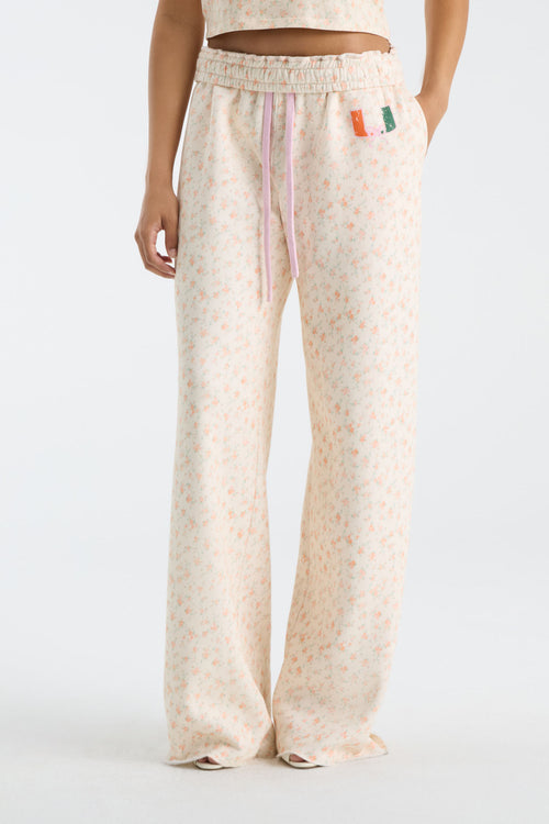 Cream floral-print wide-leg sweatpants with elastic waist and drawstring