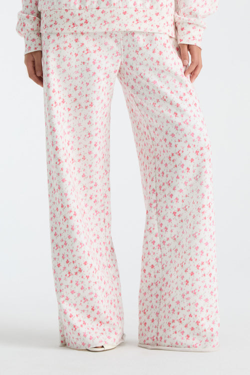 Cream floral-print wide-leg sweatpants with elastic waist and drawstring