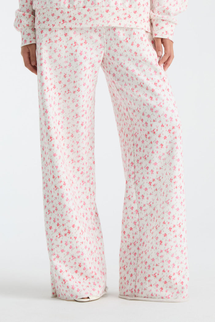 Cream floral-print wide-leg sweatpants with elastic waist and drawstring