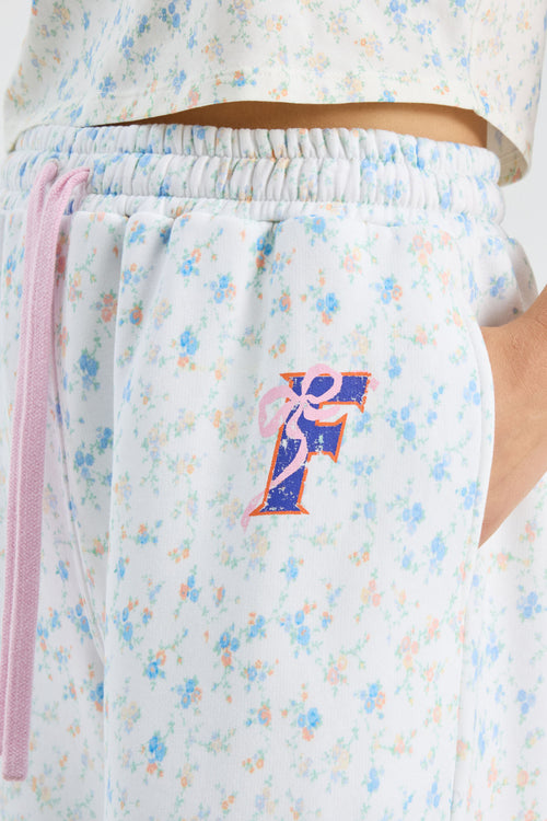White and light-blue floral sweatpants with elastic waistband and pink drawstring cord