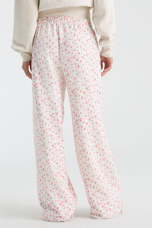 Kids pink ditsy floral sweatpants with elastic waist and relaxed wide-leg silhouette