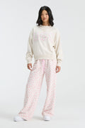 Cream mockneck crew sweatshirt with pink floral “U S C” graphic; long sleeves