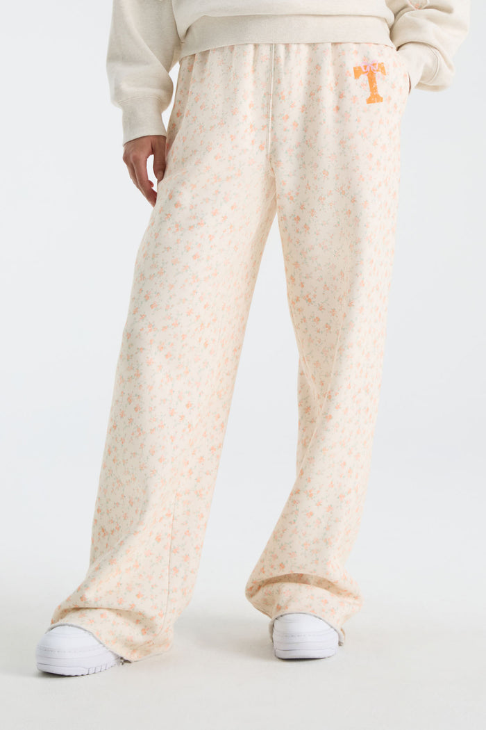 Cream floral sweatpants with elastic cuffs and wide flared legs