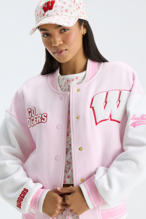 Pink varsity jacket with snap buttons, embroidered logos, and ribbed collar and cuffs