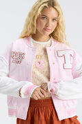 Light pink varsity jacket with T and Hook 'Em patches, ribbed cuffs, button front