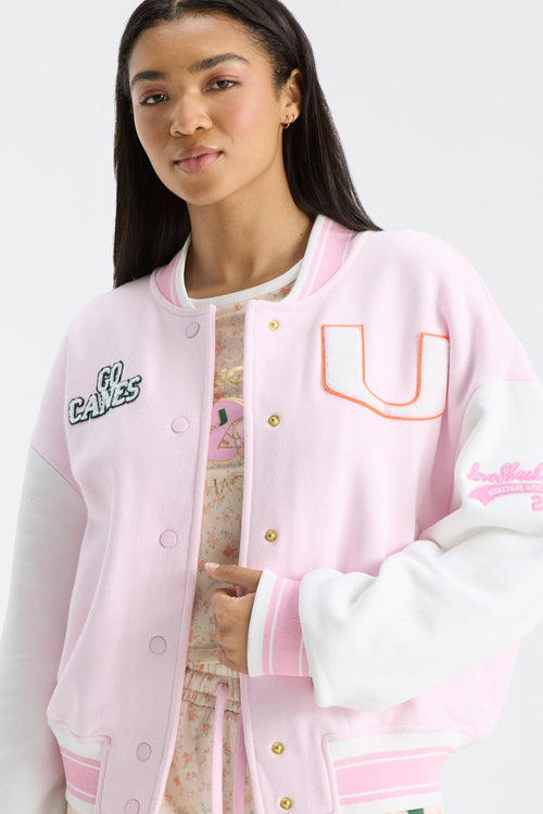 Pink varsity jacket with snap front, ribbed cuffs and hem, U logo and sleeve embroidery
