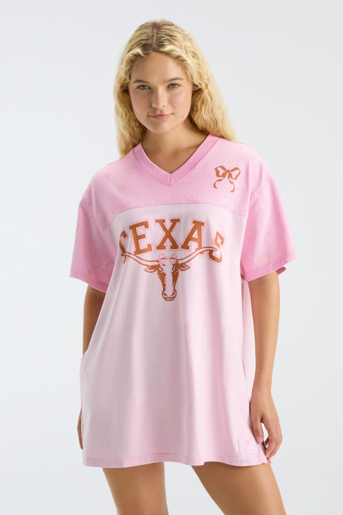 Pink V-neck jersey dress with Texas text and longhorn logo, front view