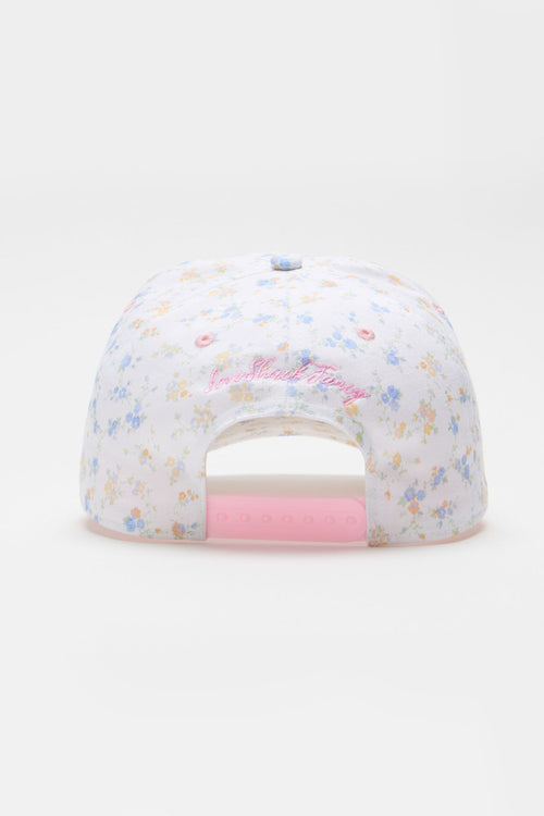 White floral baseball cap with pink cursive logo