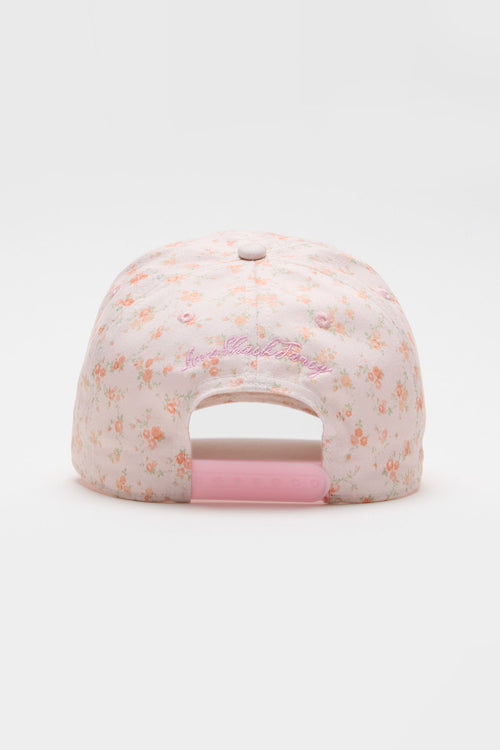 Light pink floral baseball cap with front cursive logo text