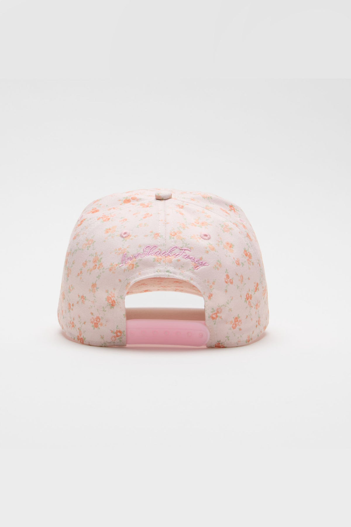Light pink baseball cap with scattered floral print and open back panel
