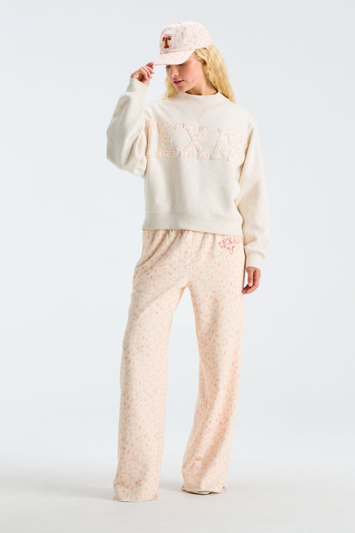 Light pink floral baseball cap worn with matching floral pajama pants