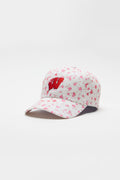 Pink baseball cap with scattered floral pattern and red letter logo on the front