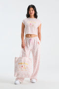 Pink patterned tote bag with printed logo text and top handles
