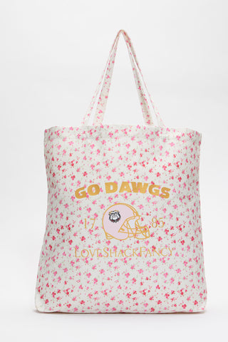 White tote bag with pink floral pattern and large printed logo graphic