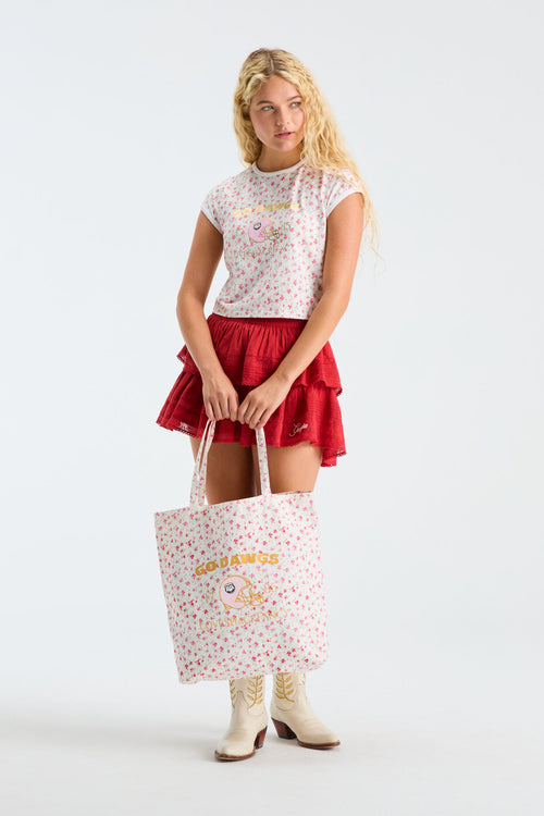 Pink patterned tote bag with printed logo graphic and top handles