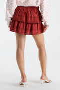 Red ruffle mini skirt with multiple gathered tiers and elastic waistband