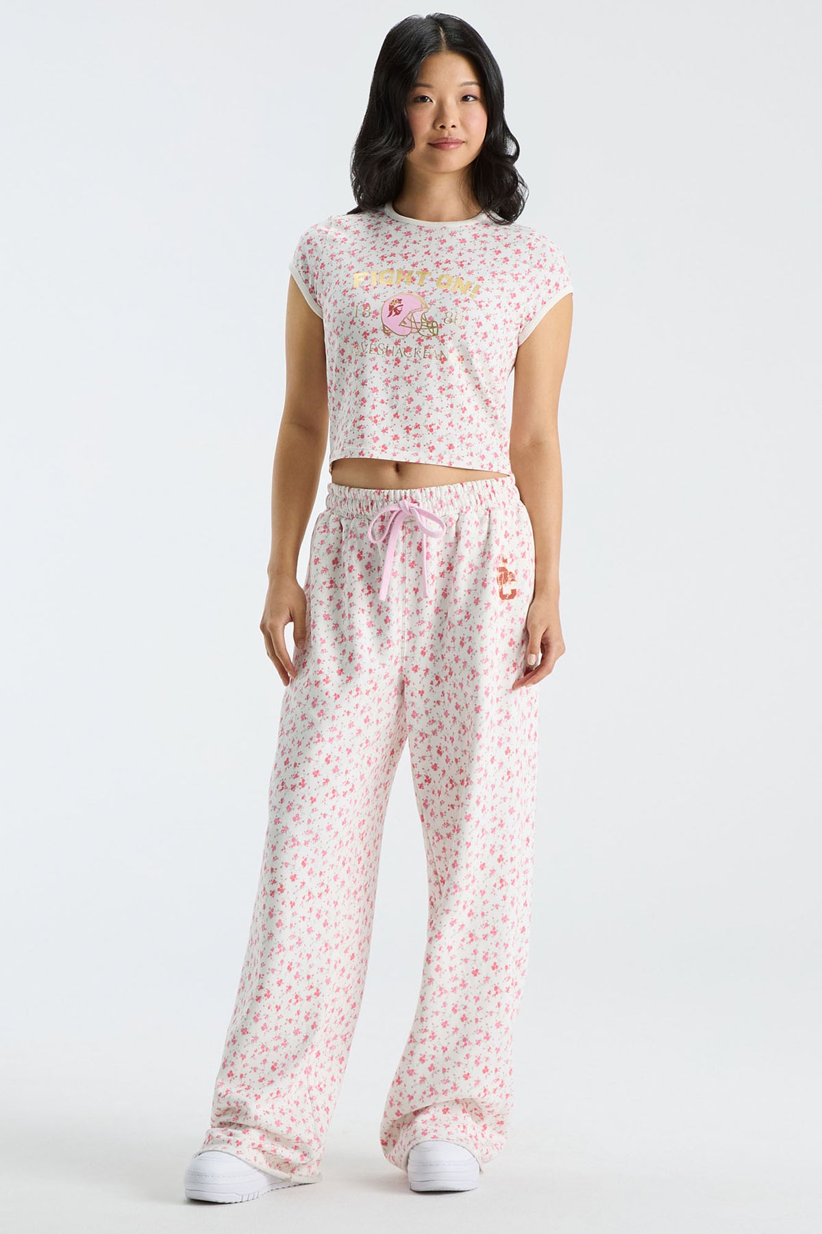 Pink floral cropped ringer tee with crew neck; model wearing matching pants