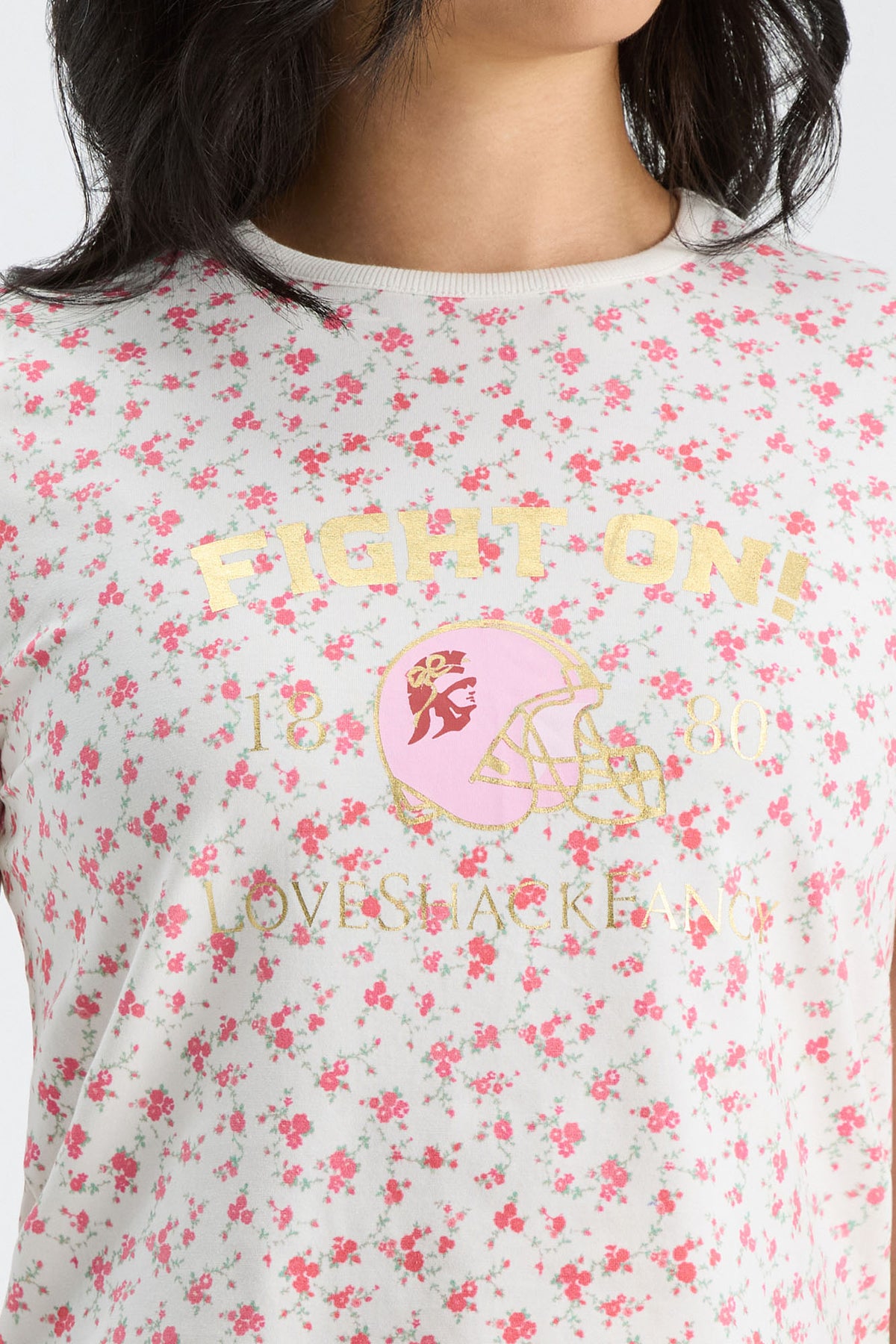 White floral ringer tee with “FIGHTON” lettering and pink helmet graphic