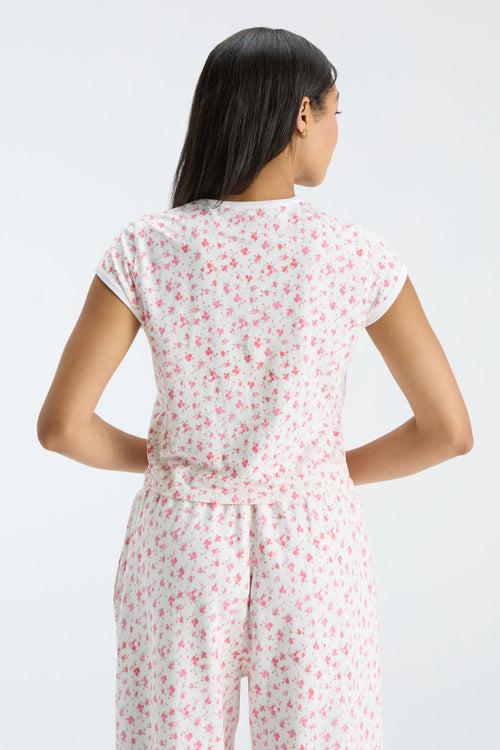 Cream floral ringer tee with white crew neck trim, back view