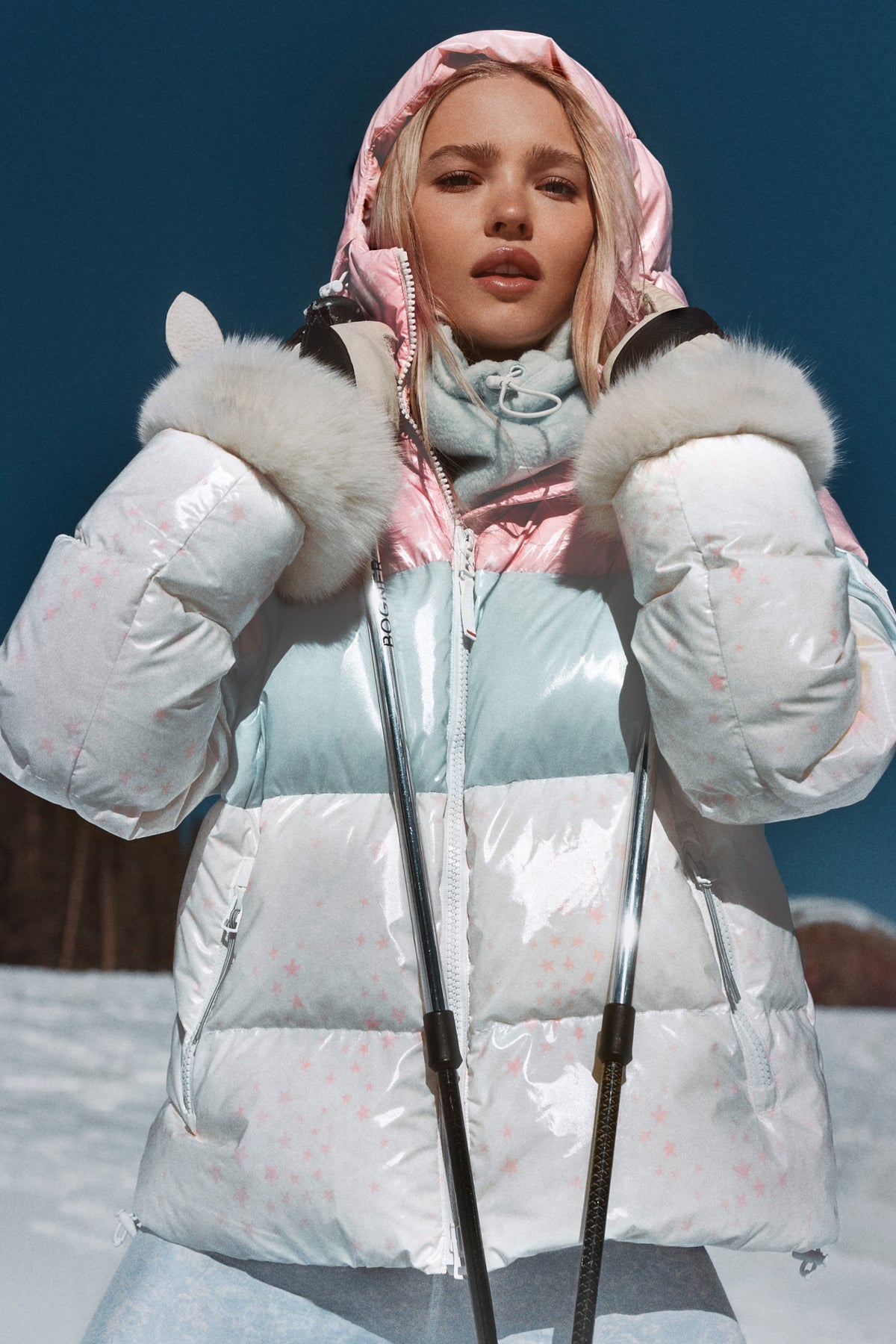 Pink hooded puffer jacket with faux-fur cuff trim and zip front, color-block quilting.