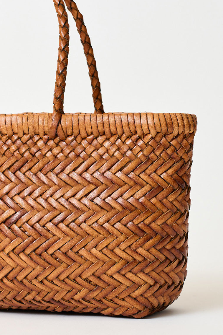 Mini woven tote bag with cognac braided handles and textured basket weave