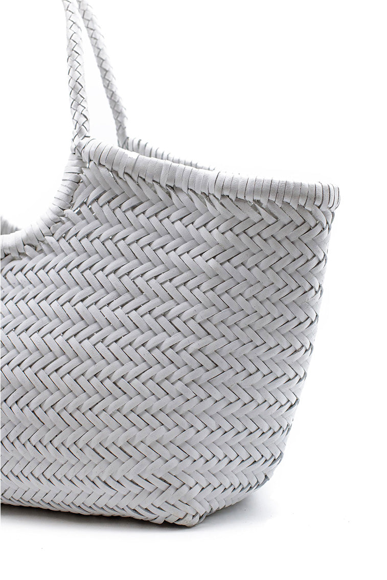 Woven tote bag side panel detail, off-white herringbone weave and loop handle