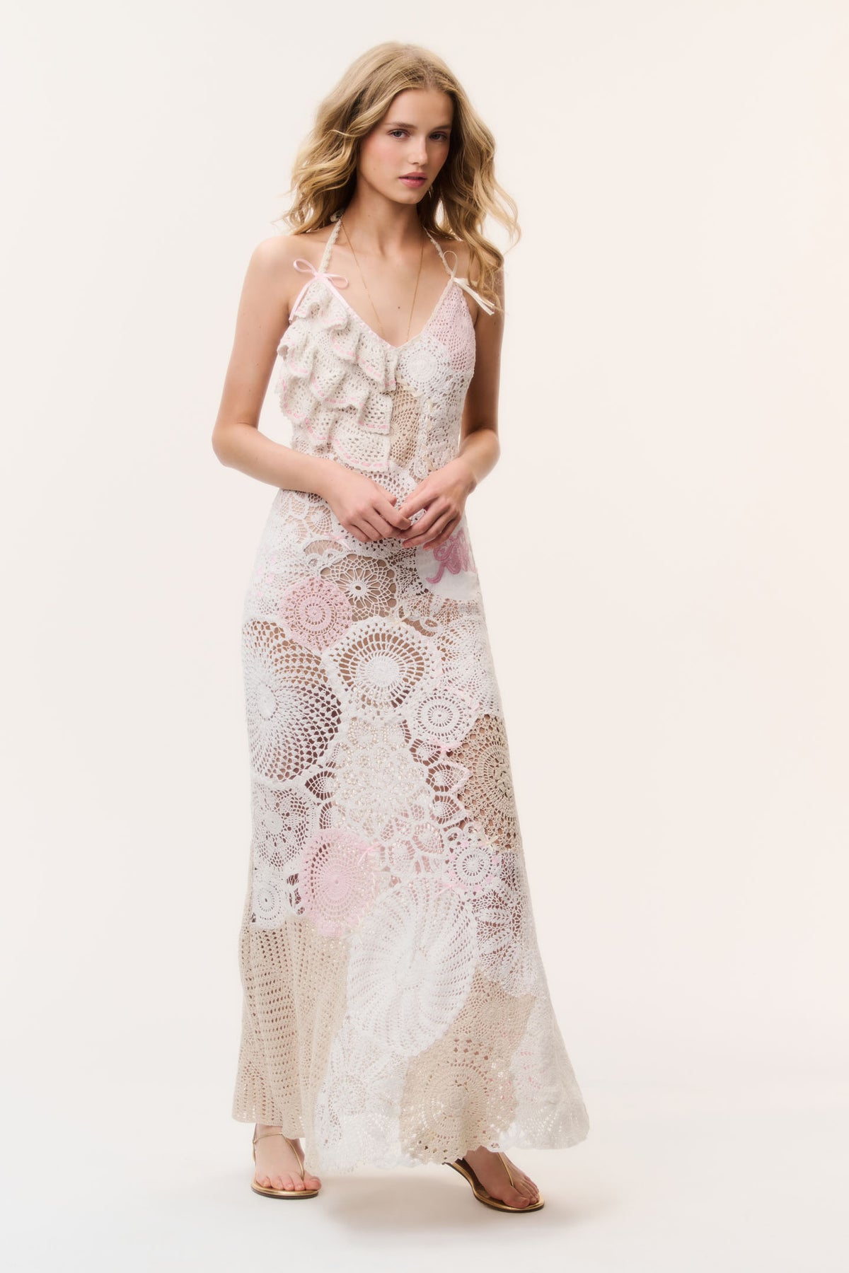 Patchwork crochet maxi dress in pale pink with thin straps and layered ruffle bodice.