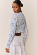 Floral print cotton cardigan in pale blue, long sleeves, back view with cropped hem