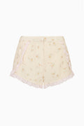 Floral lace-trimmed shorts, pale yellow with scalloped lace hem.