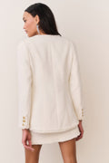Cream tweed jacket back view with gold-tone button detail at cuffs and hem