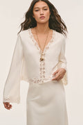 Cream crepe top with lace V-neck trim and button-front detail, long sleeves