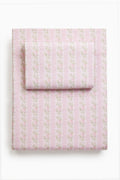 Pink printed sheet set with delicate floral pattern, neatly folded